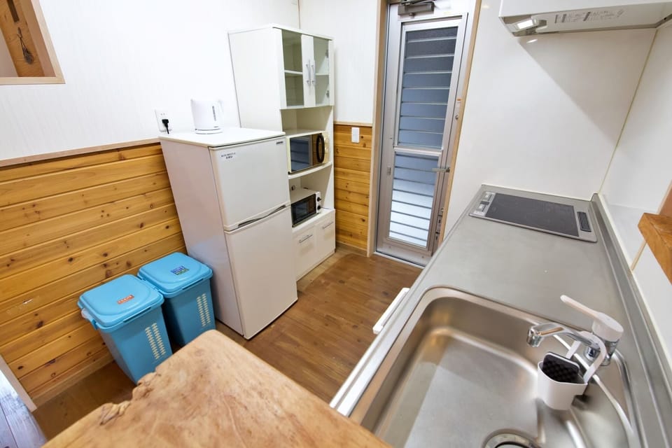 Apartment | Private kitchen | Full-size fridge, stovetop, rice cooker, cookware/dishes/utensils