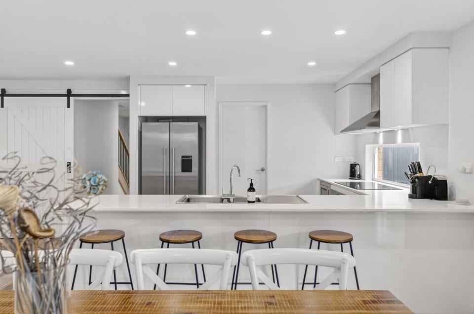 Modern kitchen with island bench and bar seating for casual dining