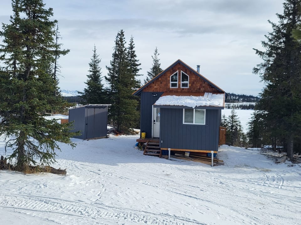 Back of Cabin and Outhouse to the left side, Caribou Lake in the background