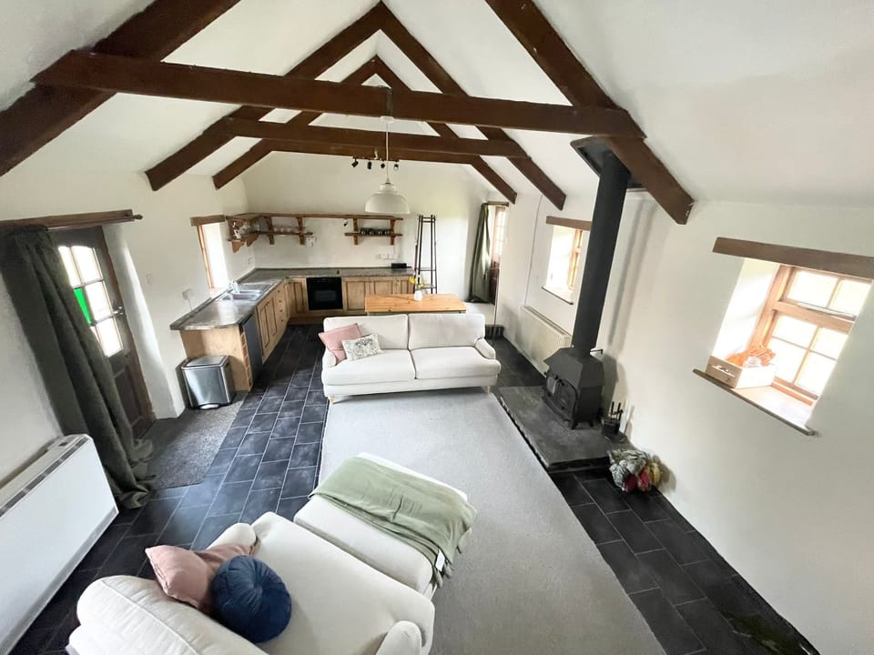 Lounge and kitchen showing log burner