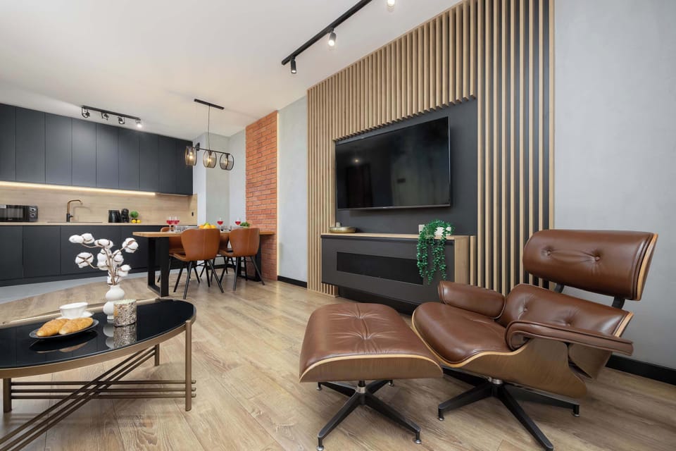 A view of the open-plan layout connecting the kitchen, dining, and living areas. The space feels airy and cohesive, with modern furnishings and a well-thought-out arrangement for everyday living.
