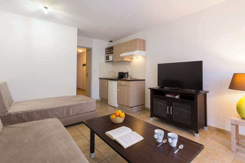 Apartment, 2 Bedrooms | Living area | 50-cm flat-screen TV with cable channels