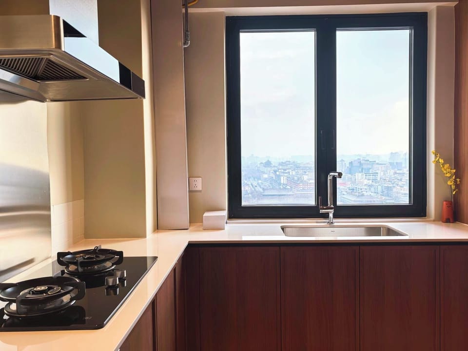 Luxury Suite, City View | Private kitchen | Electric kettle, cleaning supplies, paper towels