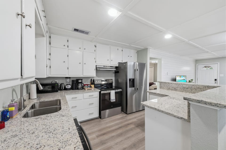 The fully equipped kitchen features granite countertops and all the essentials needed to prepare meals for a group of 12.