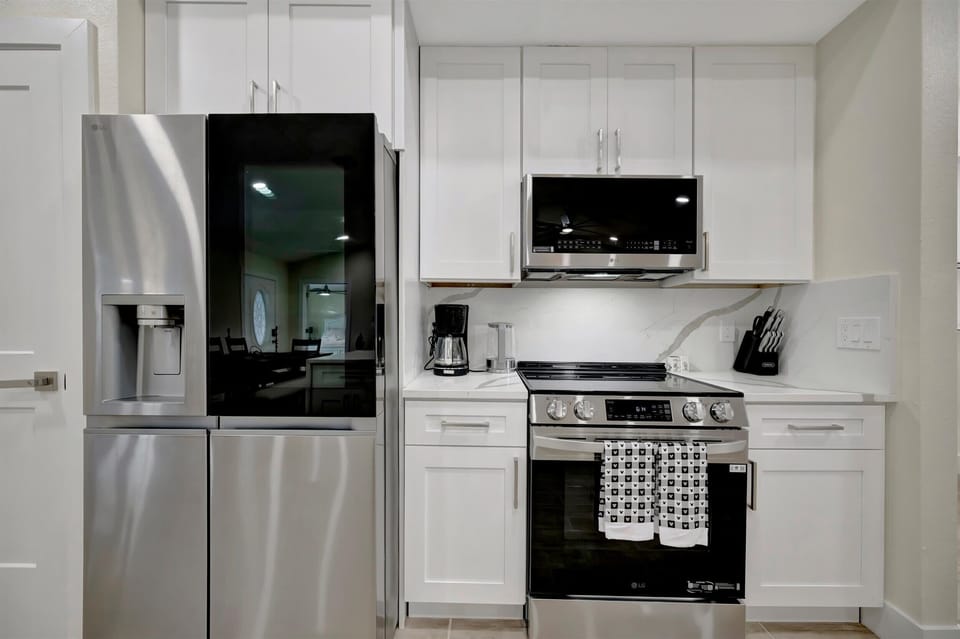 Kitchen with stainless fridge and electric range
