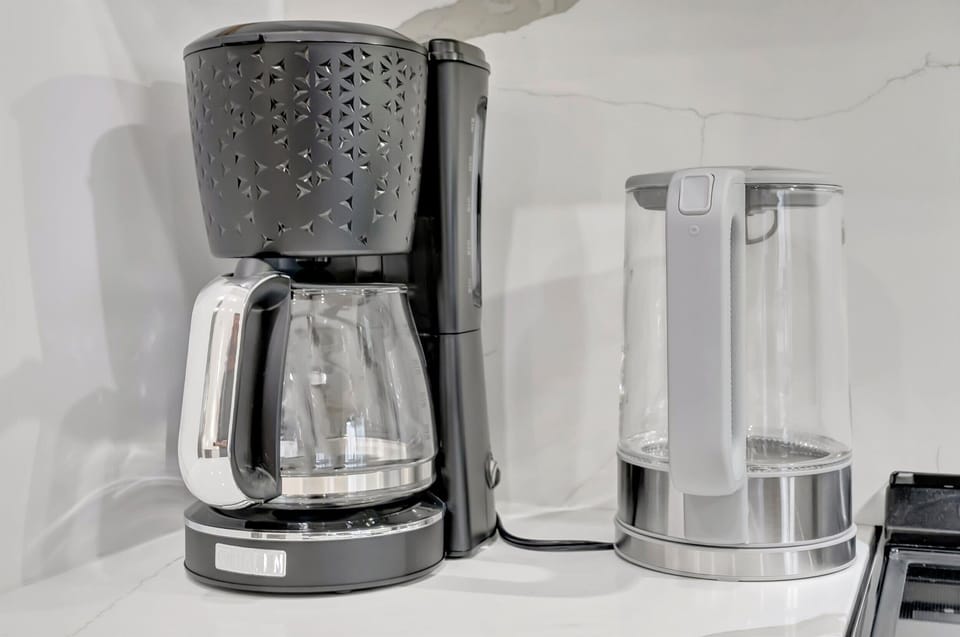 Coffee maker with water kettle on counter