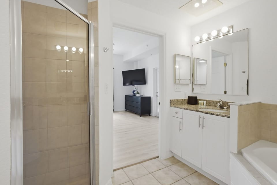 Relax in your private king retreat featuring a smart TV and easy access to the screened-in patio.