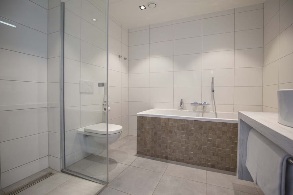 Soak deeply in the tub, then rinse in the walk-in shower.
