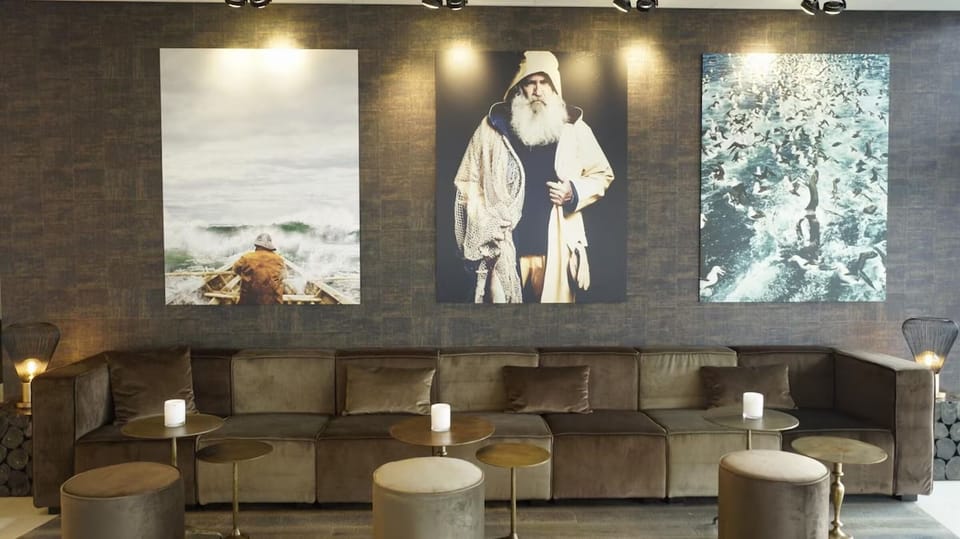 Relax into plush seating beneath curated art and warm lighting.