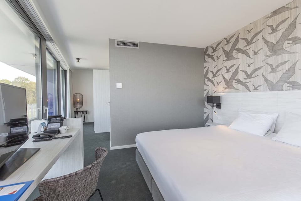 Ease into work or play at the desk beside sunlit windows.