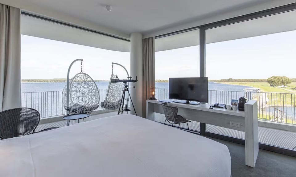 Wake up above the water with panoramic views and balcony seating.
