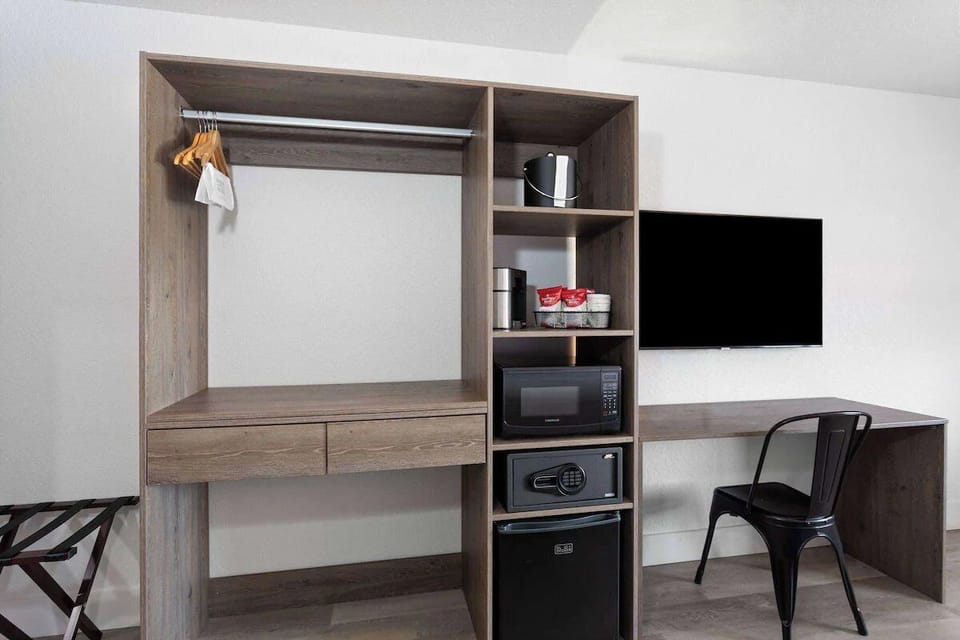 Organize effortlessly with open closet storage and luggage rack.