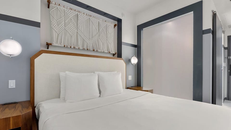 Drift off under soft sconces and boutique textures overhead.
