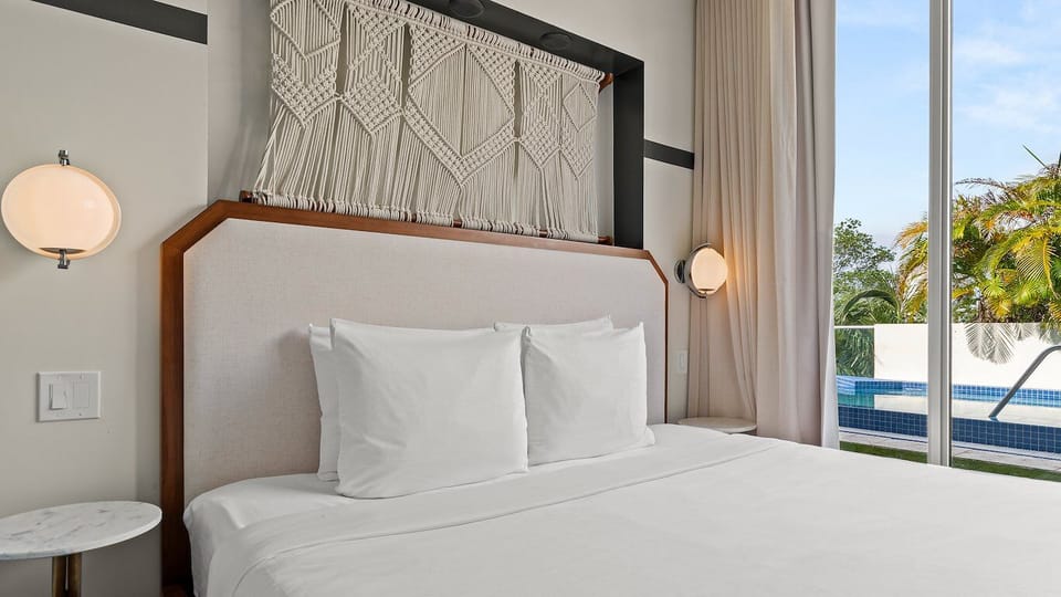 Drift off with poolside views and softly glowing bedside lights.