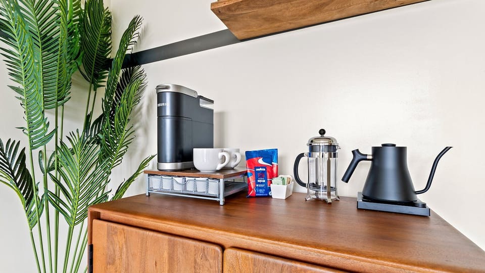 Start mornings with fresh coffee and a cozy in-room setup.