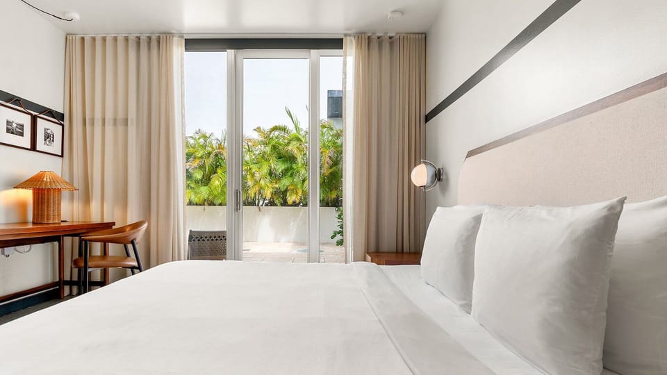 Wake up to palm views framed by soft, airy curtains.