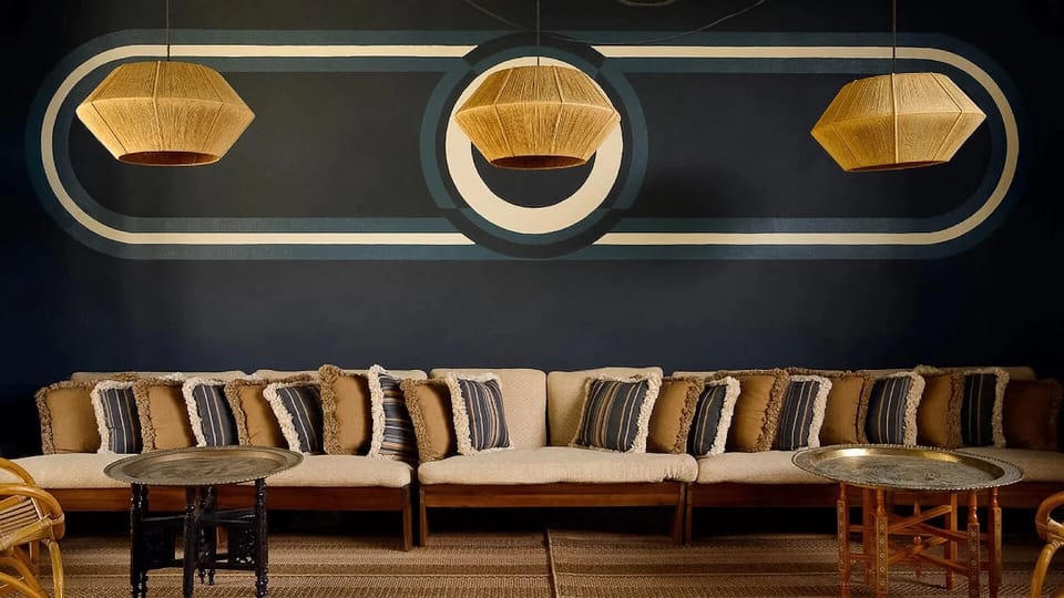 Unwind on plush seating under statement lighting and murals.
