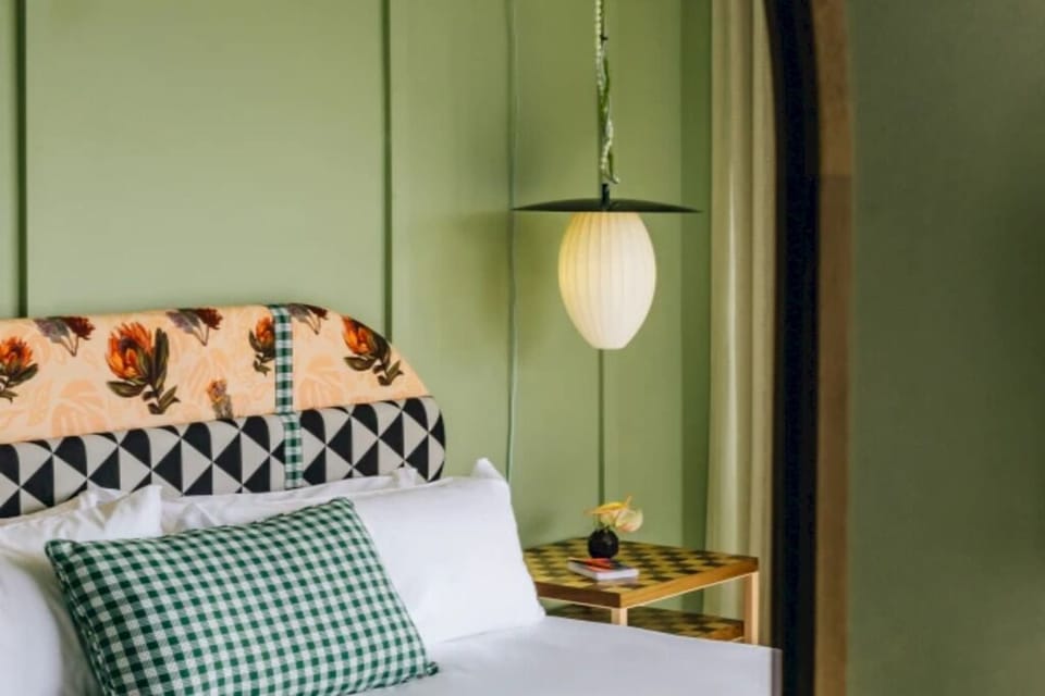 Sink into crisp linens beneath warm, designer lighting.