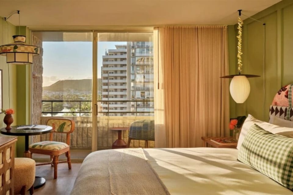 Wake up to golden light and balcony views from bed.