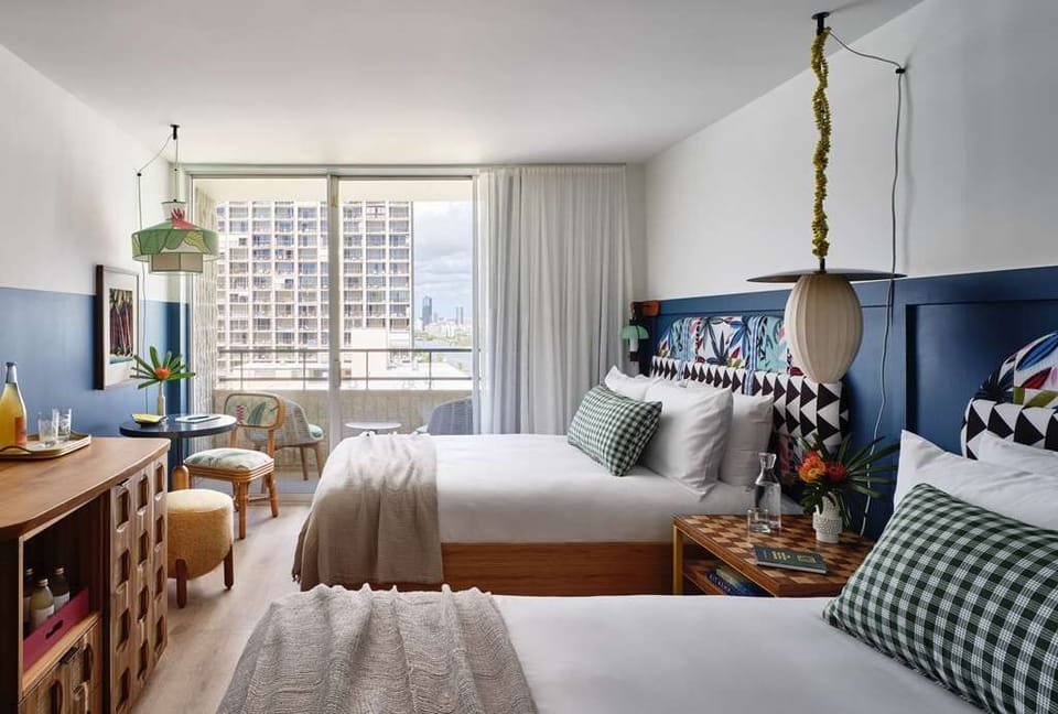Unwind in crisp beds beside breezy floor-to-ceiling windows.