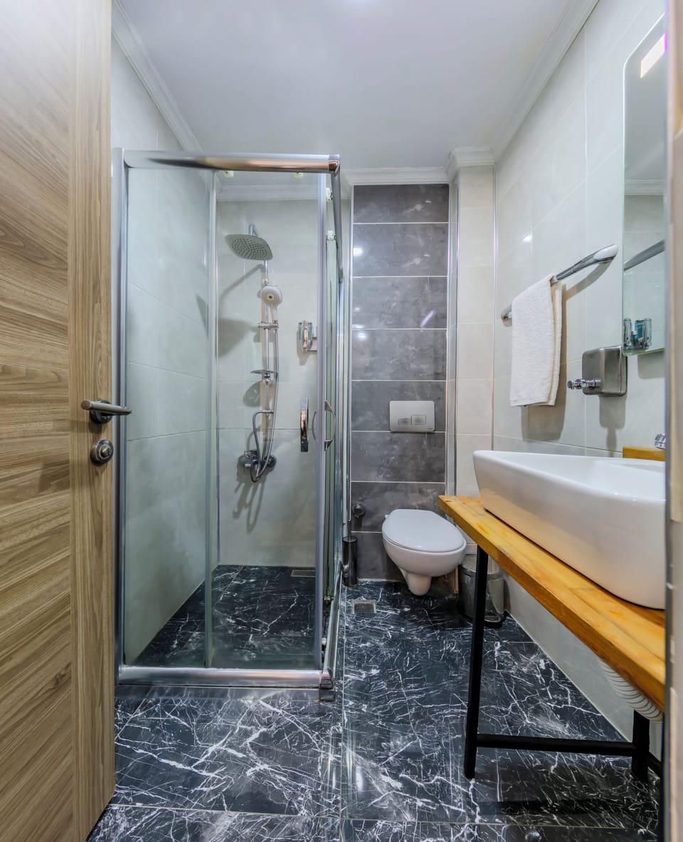 Shower, hair dryer, slippers, towels