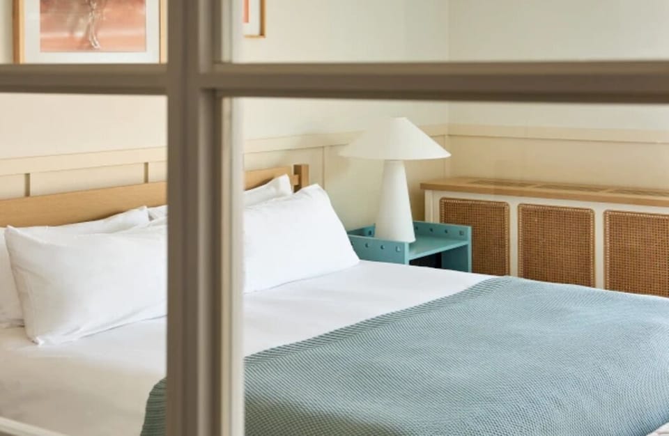 Relax in a quiet bedroom with clean lines and comfort.