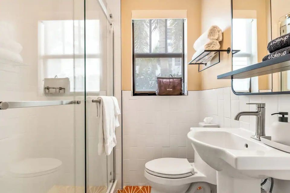 Rinse off in a bright, glass shower after beach days.