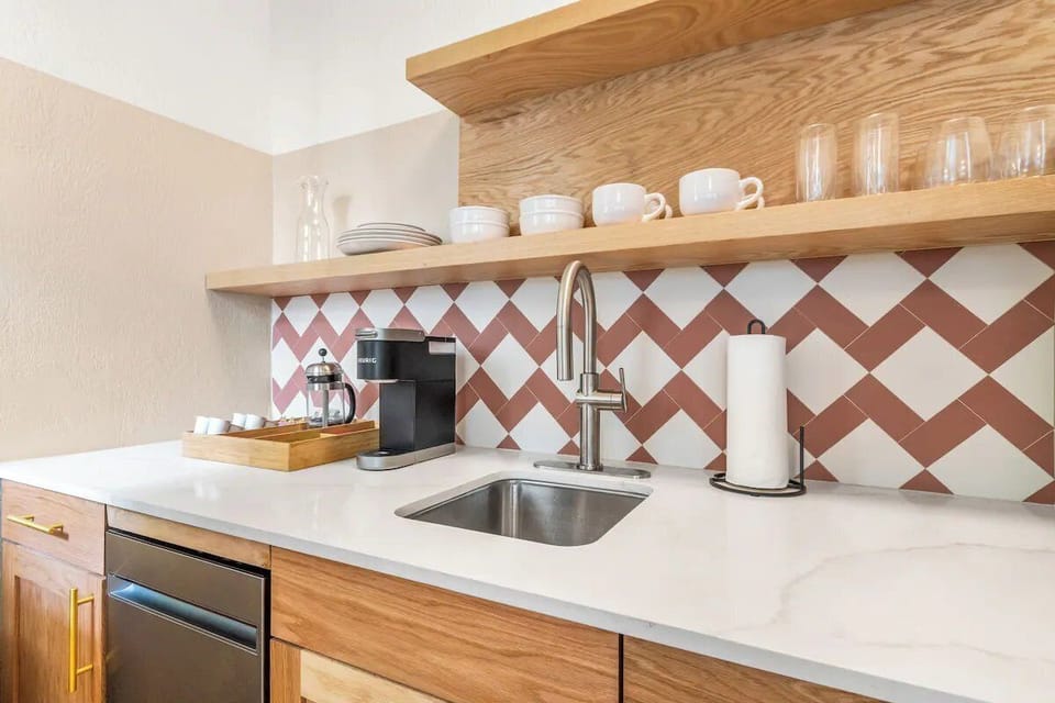 Pour fresh espresso and prep snacks on smooth stone counters.