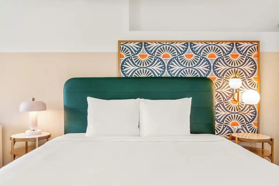 Sink into plush pillows against a bold, stylish headboard.