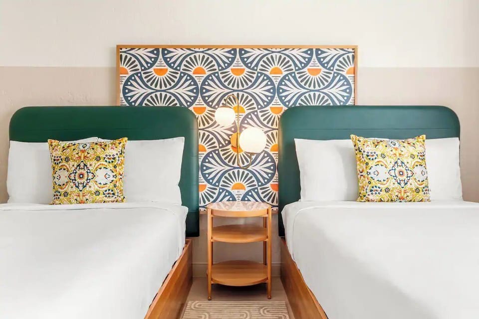 Drift off between plush pillows and vibrant, cheerful headboards.