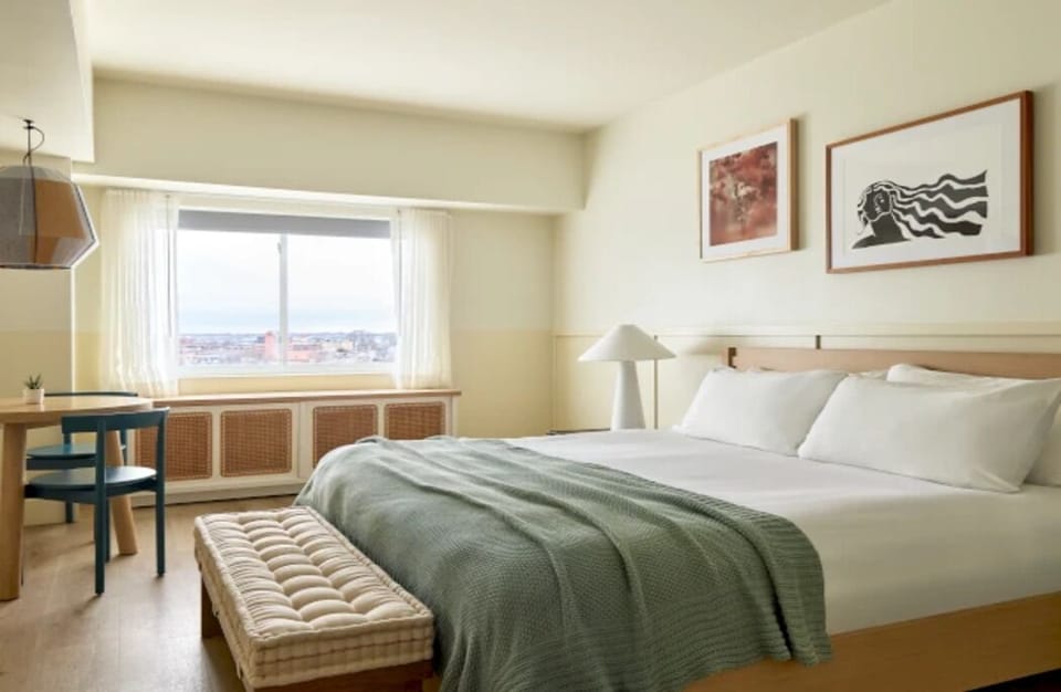 Wake up to soft daylight and a calming city view.