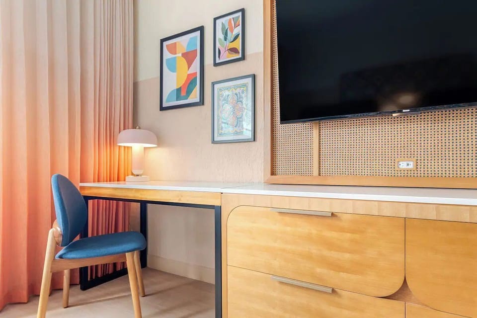 Work comfortably with a spacious desk beside soft drapery light.