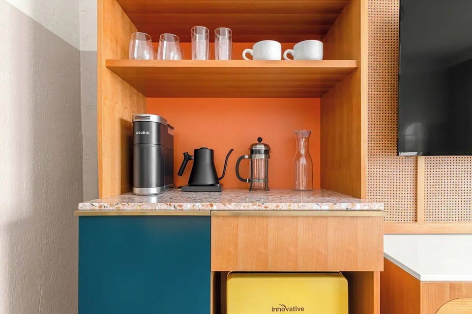 Start mornings with a compact kitchenette for easy snacks.