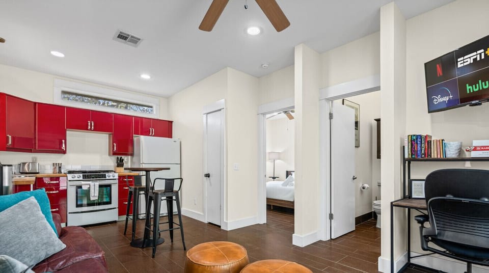 Open sightlines connect the kitchen, living area, and workspace so everyone stays part of the conversation.