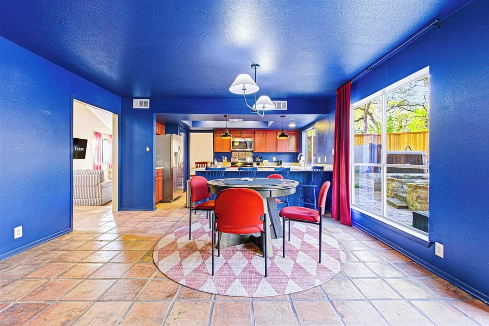 Enjoy the best of both worlds in our open-concept living and dining area. Whether you're gathering for a card game or prepping snacks in the kitchen, you’re always just a glance away from the pool and hot tub.