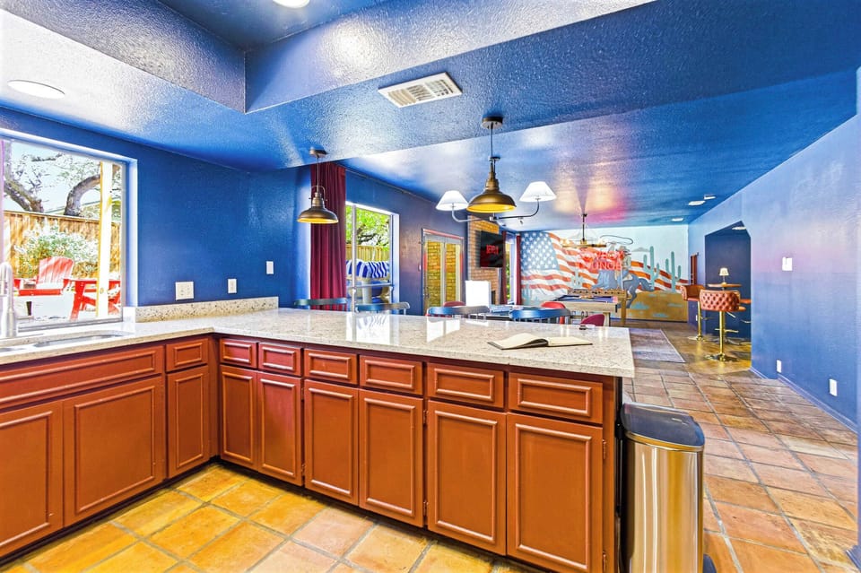 This kitchen shot is the final piece of the puzzle! It shows how the heart of the home connects directly to the game room and the pool area, making it a dream for anyone who loves to host.