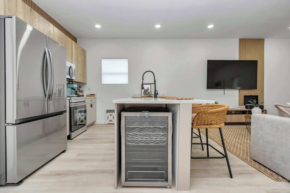 Modern kitchen w/ stainless appliances, sleek finishes & island seating for casual meals