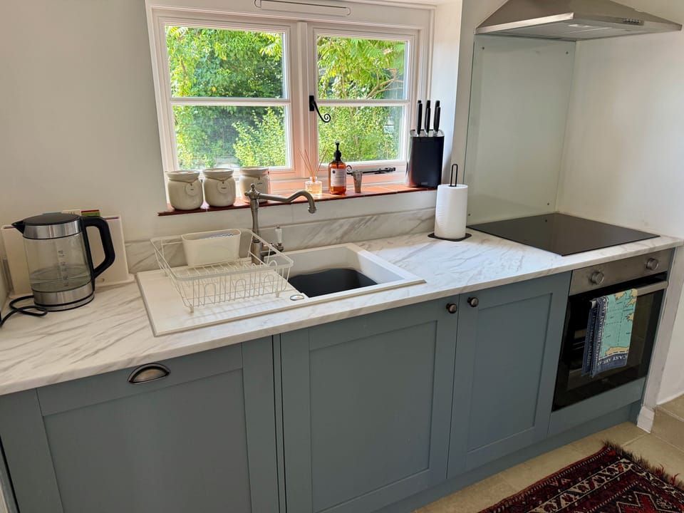 Modern kitchen with all the latest appliances, including dishwasher, cooker, hob