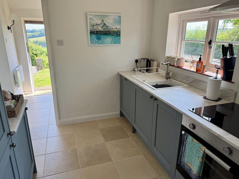 Full kitchen with all modern appliances & adjoining boot room for muddy shoes.