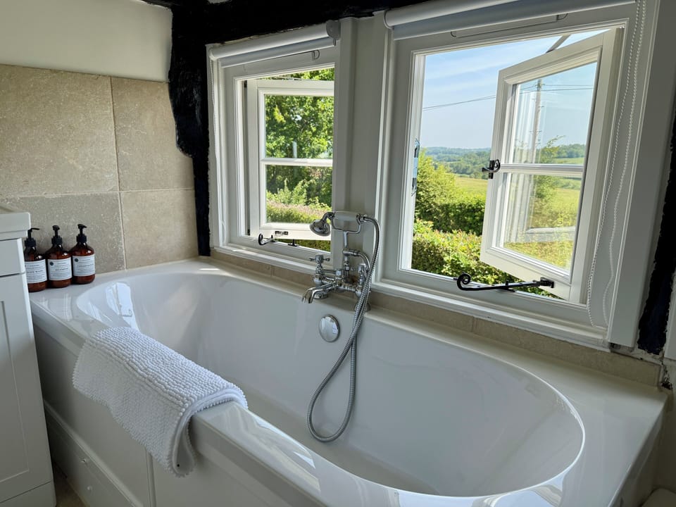 Modern bathroom with panoramic countryside views from your private bath.