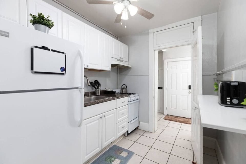 Enjoy a clean, modern aesthetic with crisp white cabinets and ample prep space.
