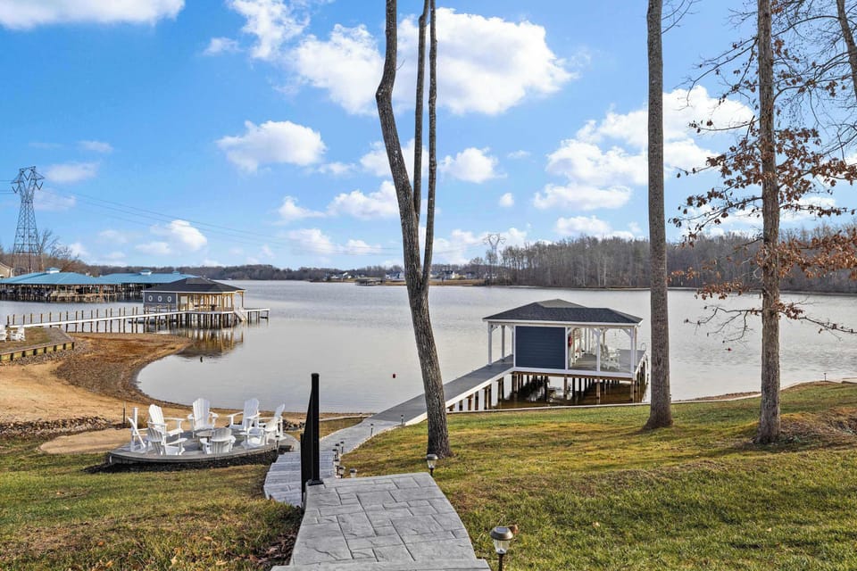 Boathouse - The path from the fire pit leads to the covered boathouse over the water, with Adirondack chairs and a kayak rack along the way.