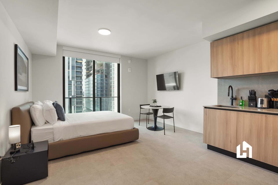 Queen bed, living, kitchen, and dining all in one space