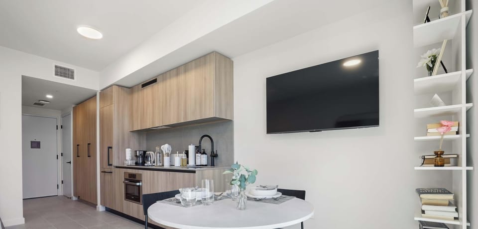 Open-concept dining and living area with wall-mounted TV
