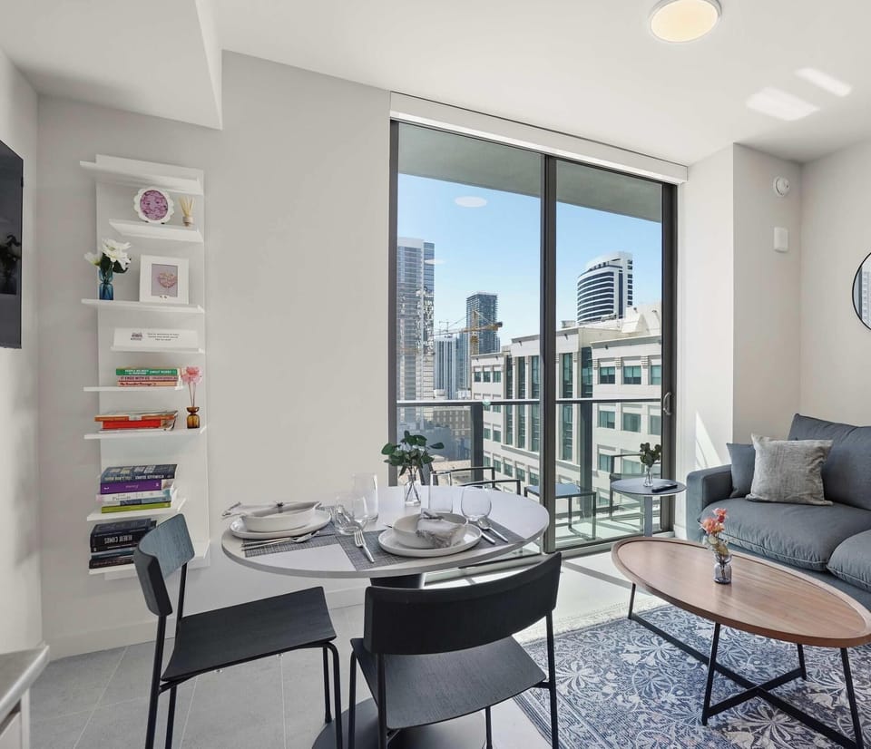 Modern living area with stylish seating and city backdrop
