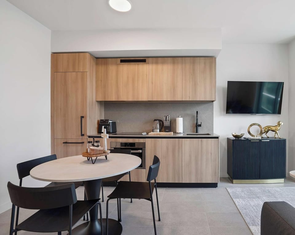 Contemporary layout combining the kitchen, dining, and living spaces.
