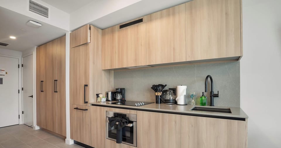 A fully equipped kitchen seamlessly integrates with the living area, perfect for entertaining.
