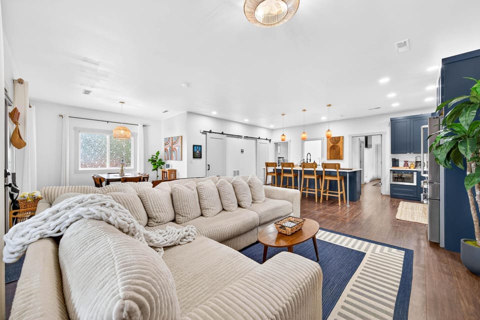 Spacious open living area with cozy sectional and modern kitchen