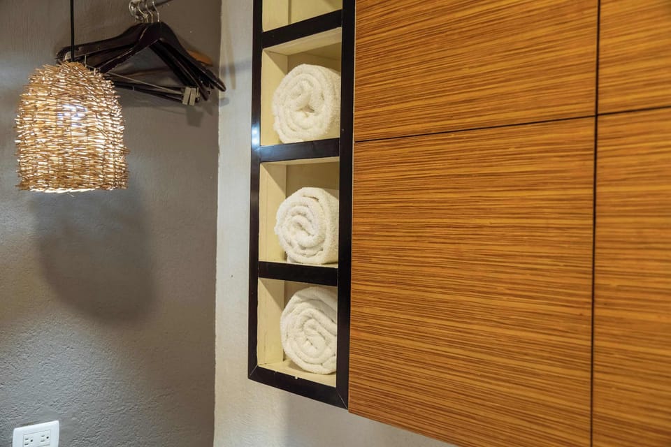 Handy wardrobe with fresh towels and hangers, thoughtful touches to make the stay feel like home