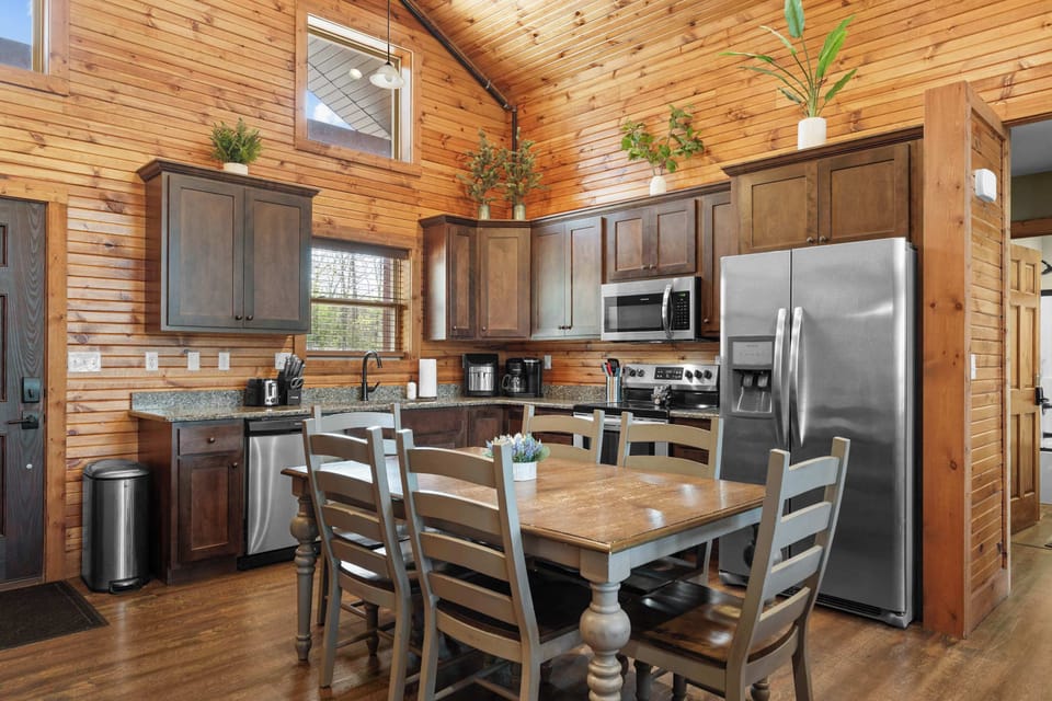 The kitchen greets you as you enter the cabin with stainless steel appliances and cabinets full of cookware!